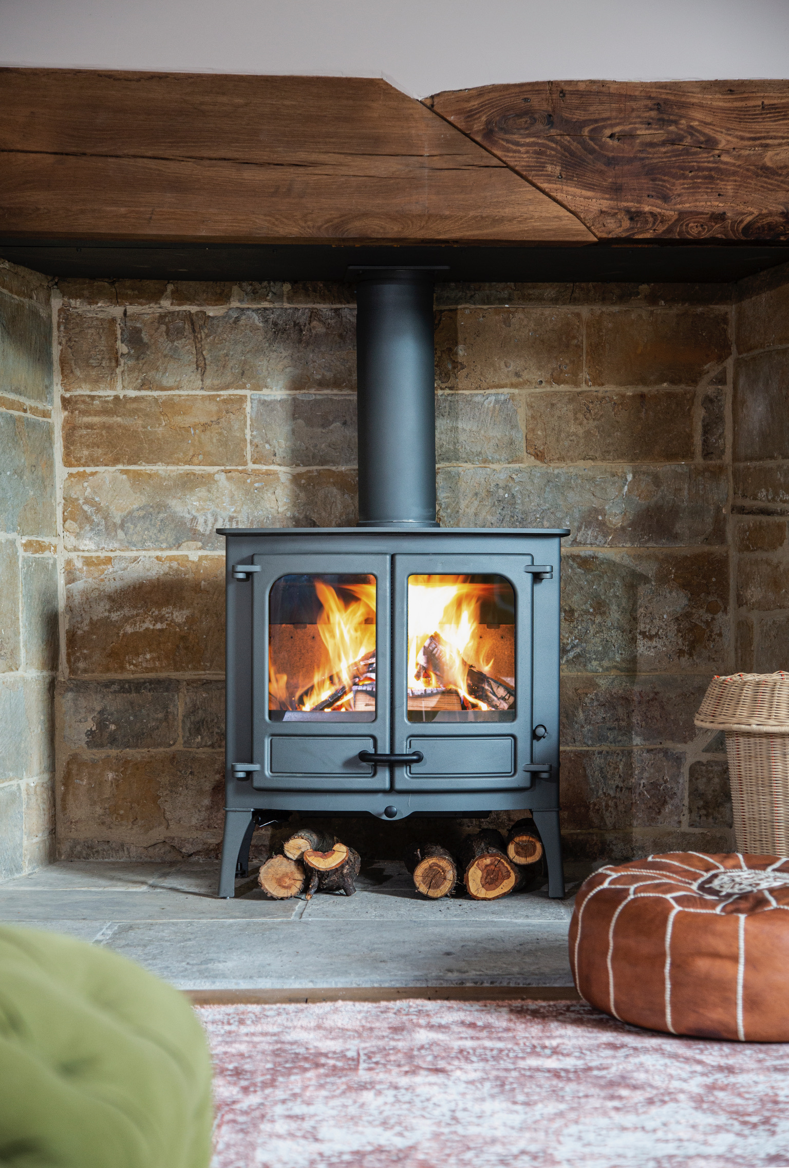 Free-standing wood stove style often installed with careful ventilation and flue planning